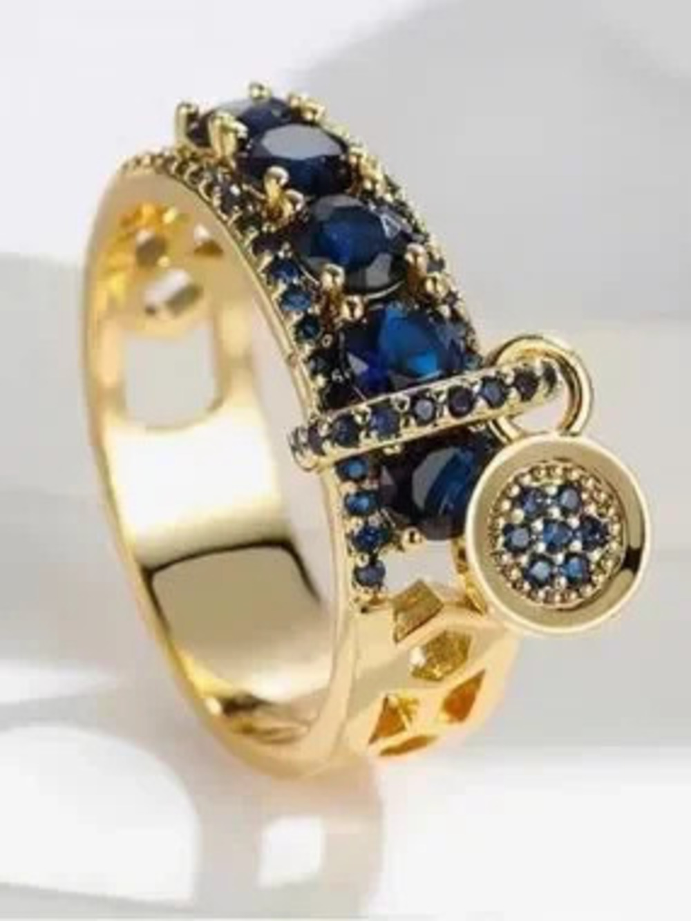 Gold Ring with Deep Blue Gemstones and Charm